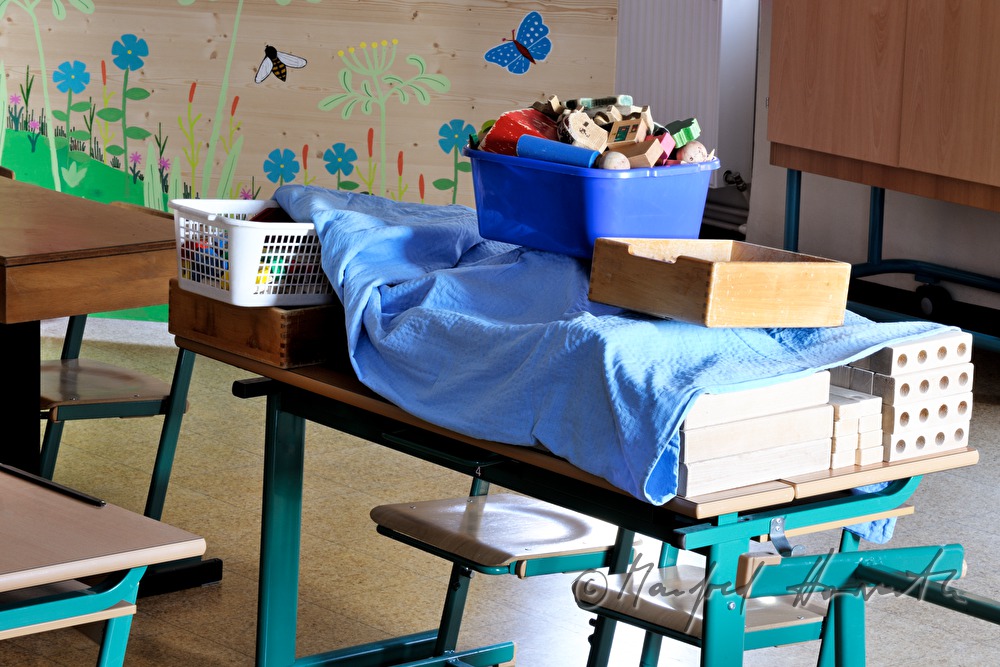 covered toys on a school desk