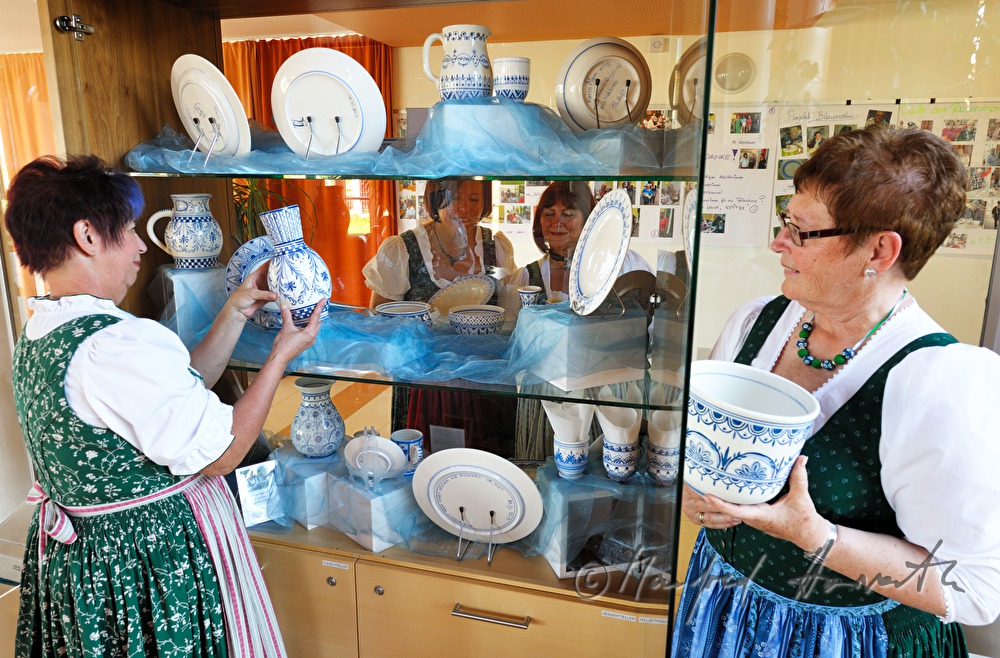 arranging the exhibits for a pottery exhibition
