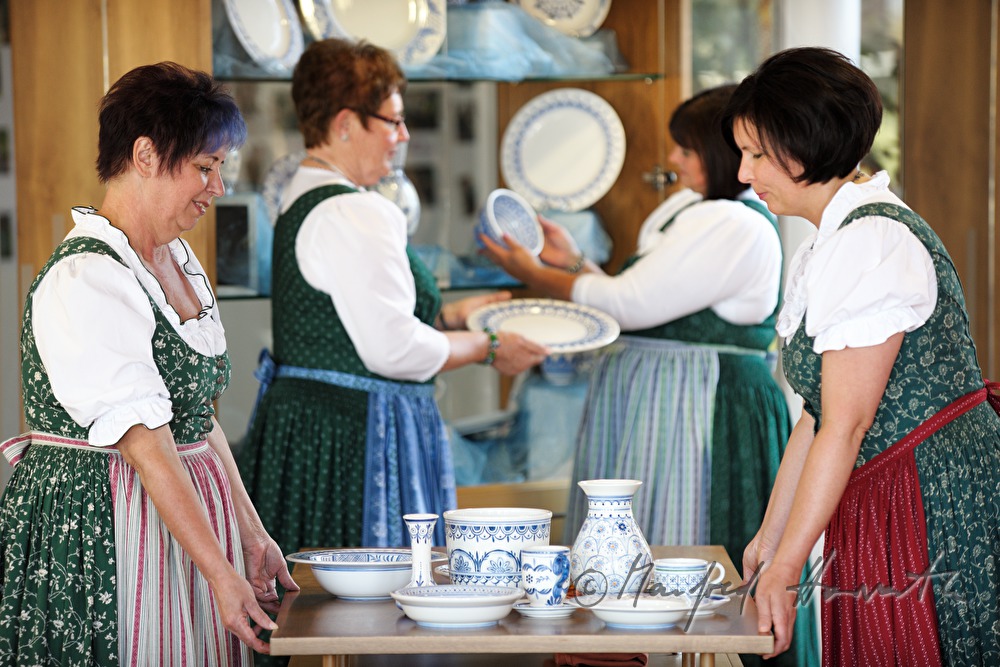 arranging the exhibits for a pottery exhibition