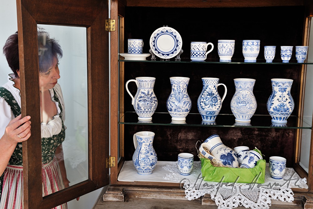 arranging the exhibits for a pottery exhibition
