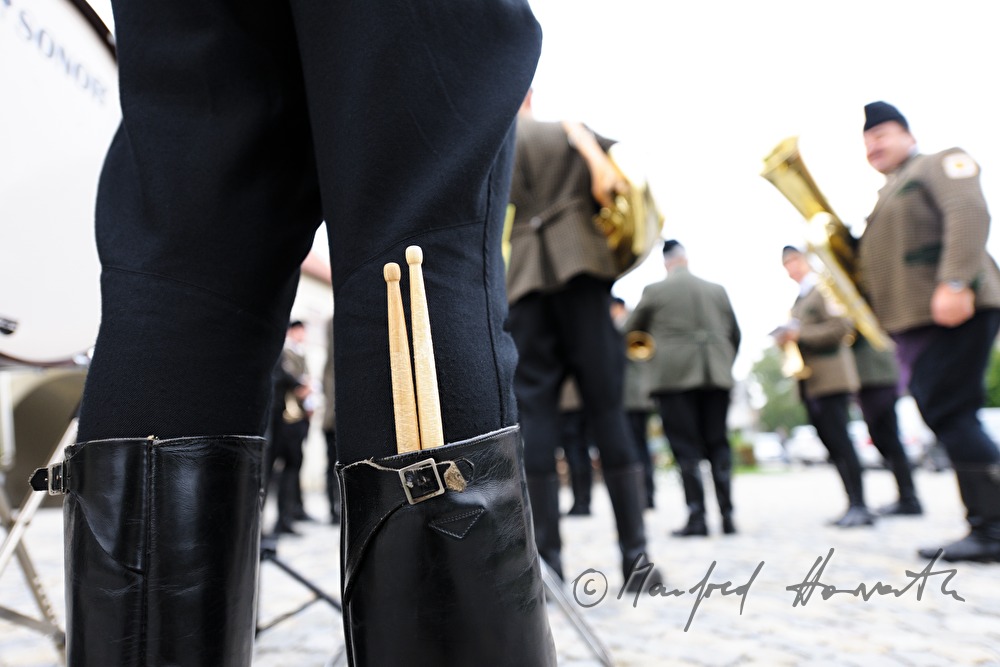 drummer of the folk music band keeps drumsticks in his boots