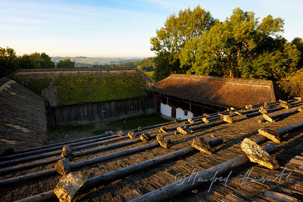 farmhouse with thached roof and stones on the shingle roof