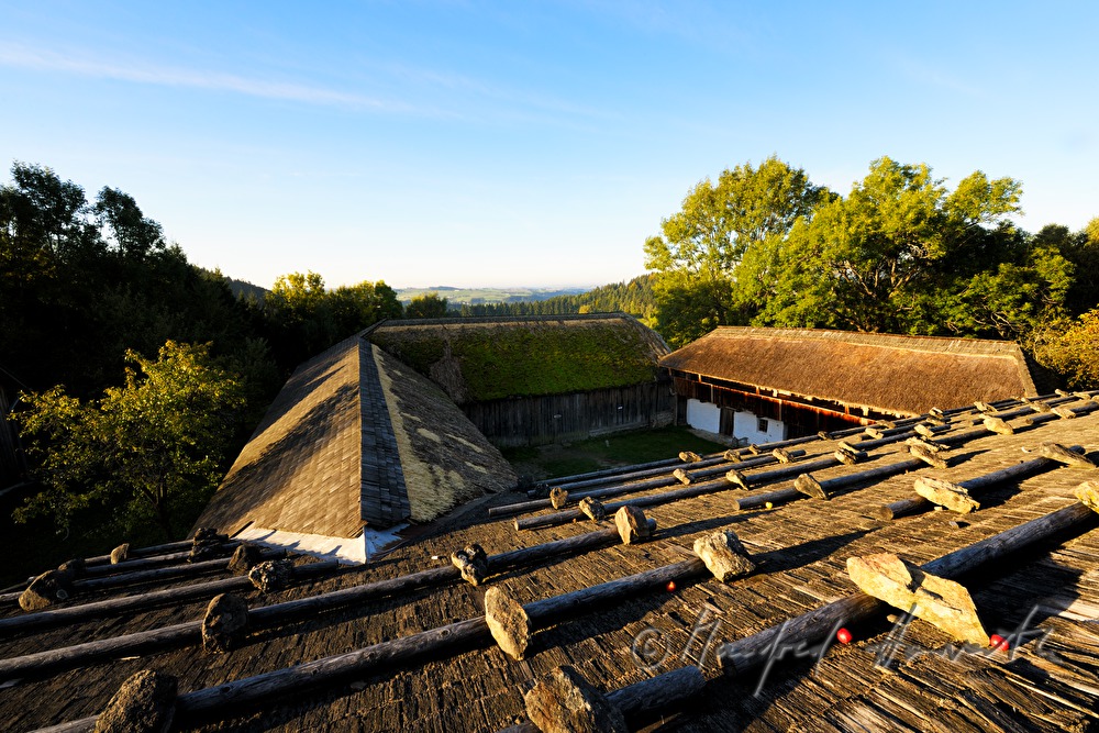 farmhouse with thached roof and stones on the shingle roof