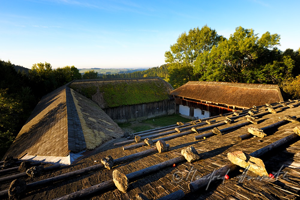 farmhouse with thached roof and stones on the shingle roof