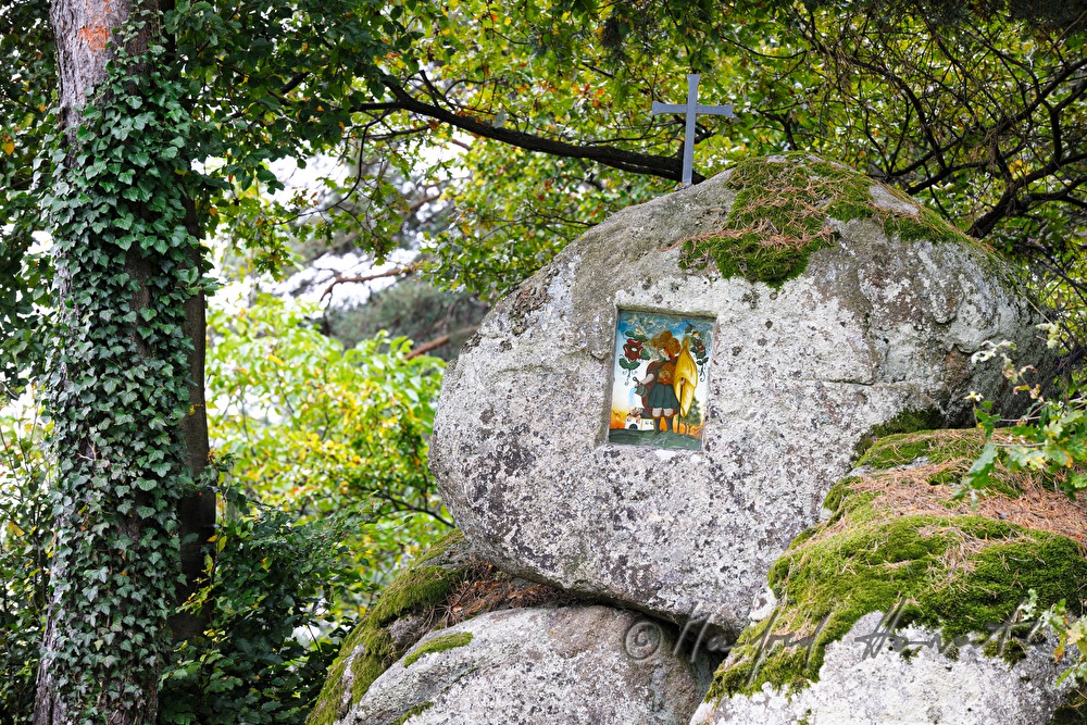 erratic boulders with a cross and Saint Florian