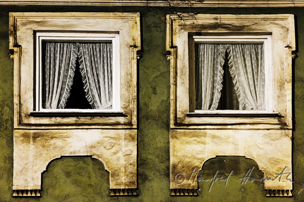 windows with curtains of a town house