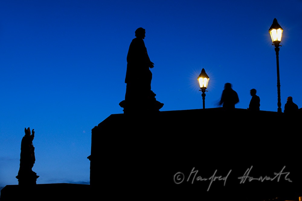 figures of saints on the old bridge over the river Main