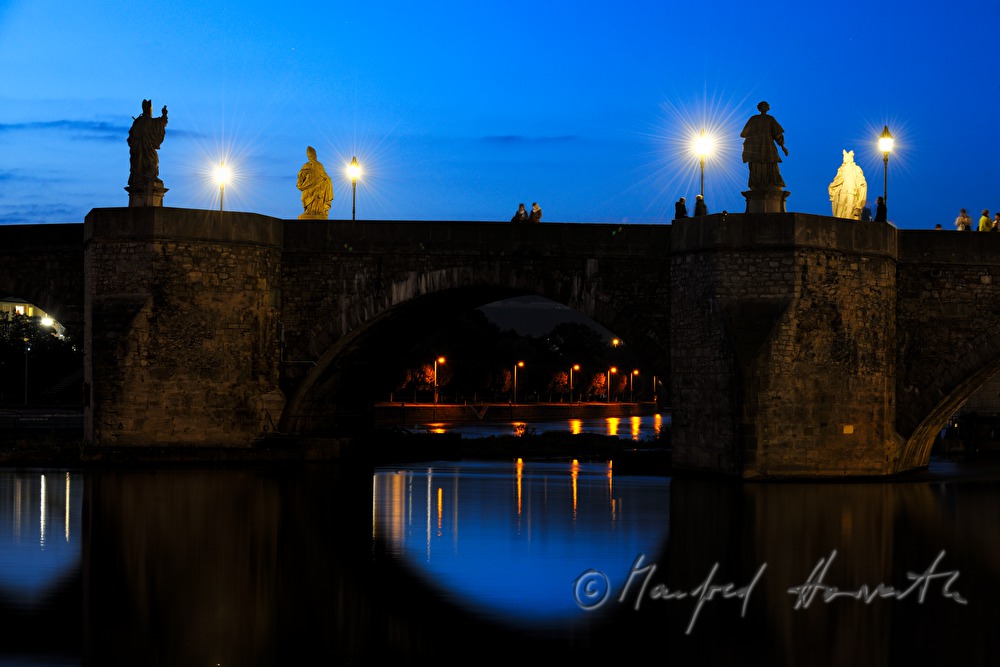figures of saints on the old bridge over the river Main