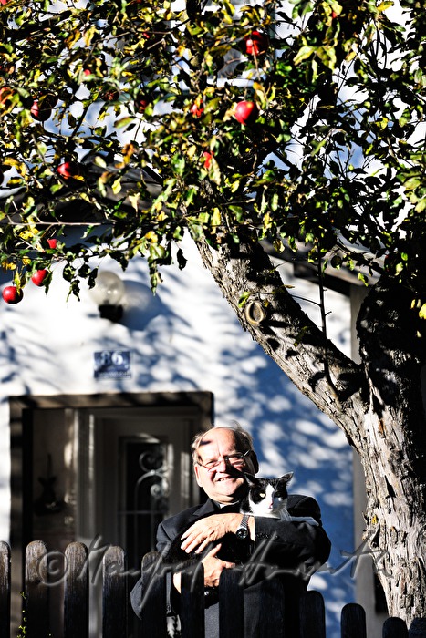 reverend Josef Kantusch with his cat in front of his parsonage