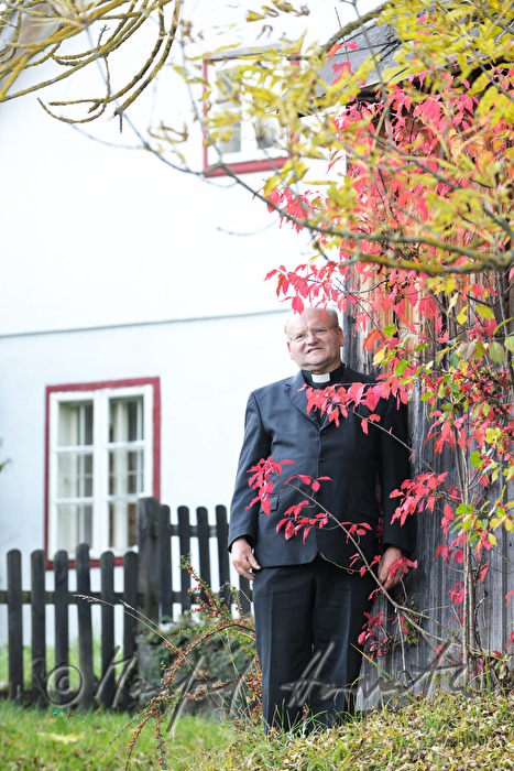 reverend Josef Kantusch in front of his parsonage