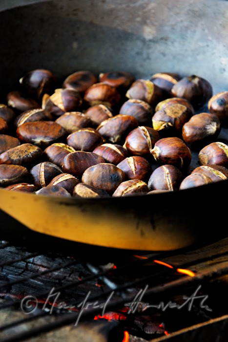 making of baked chestnuts at the chestnut festival
