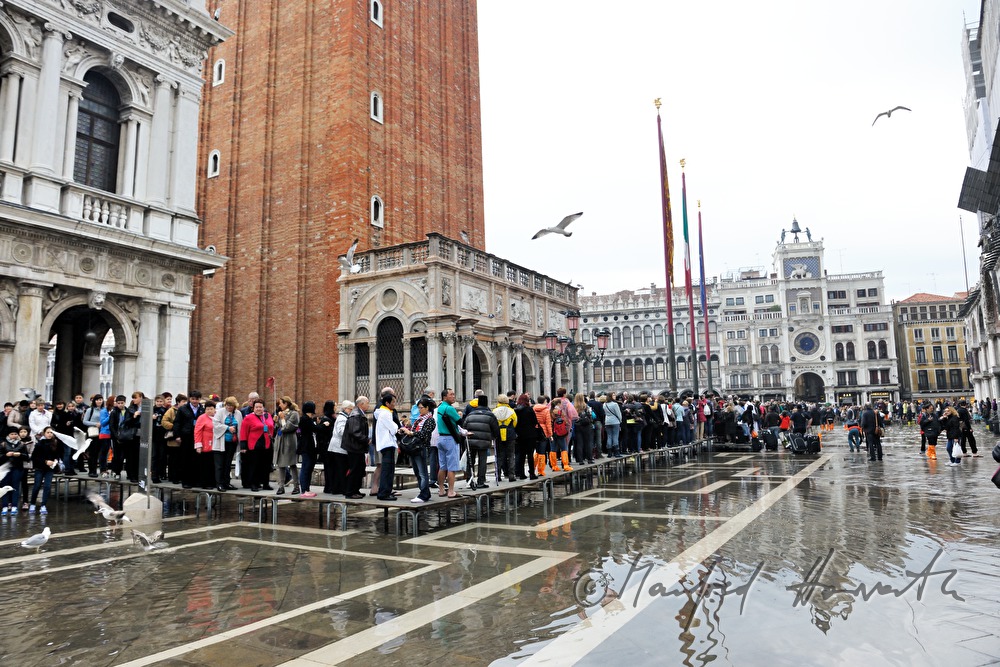 tourists on Piazza San Marco during Acqua alta