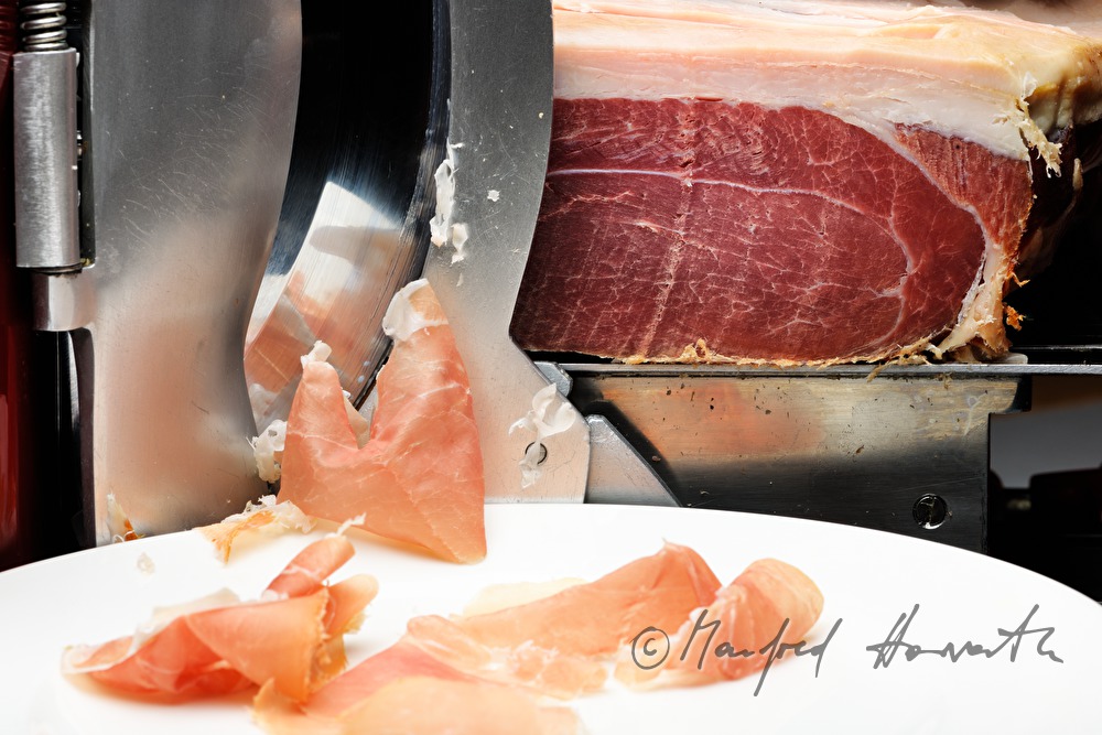 Vulcano Ham on the slicing machine in the restaurant