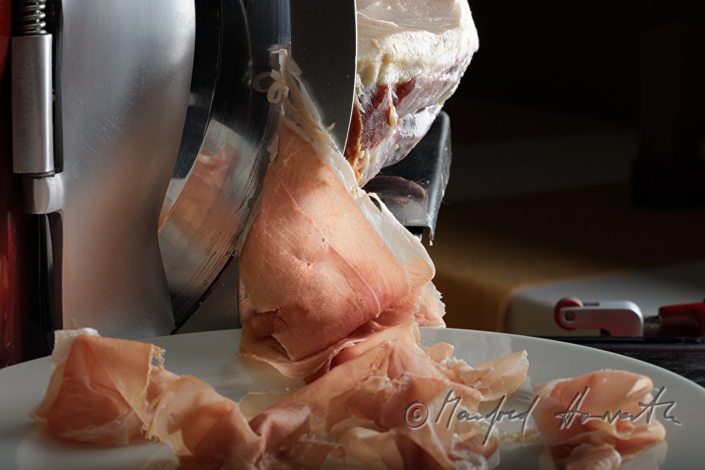 Vulcano Ham on the slicing machine in the restaurant