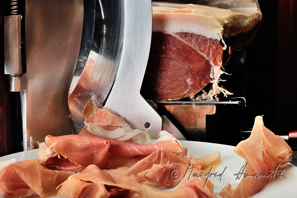 Vulcano Ham on the slicing machine in the restaurant
