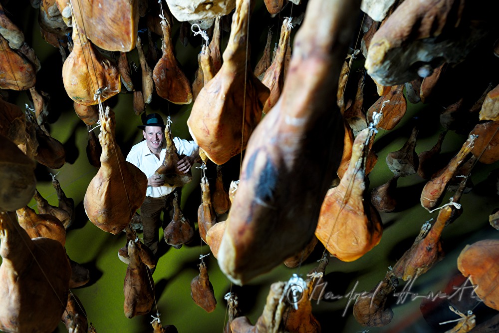 Franz Habel in the ripening room with Vulcano (air dried cured ham)