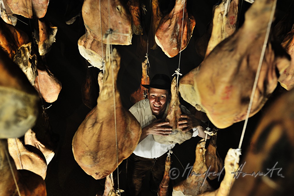 Franz Habel in the ripening room with Vulcano (air dried cured ham)