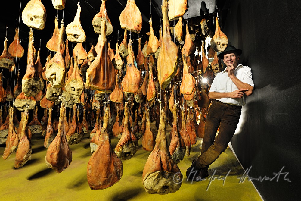 Franz Habel in the ripening room with Vulcano (air dried cured ham)