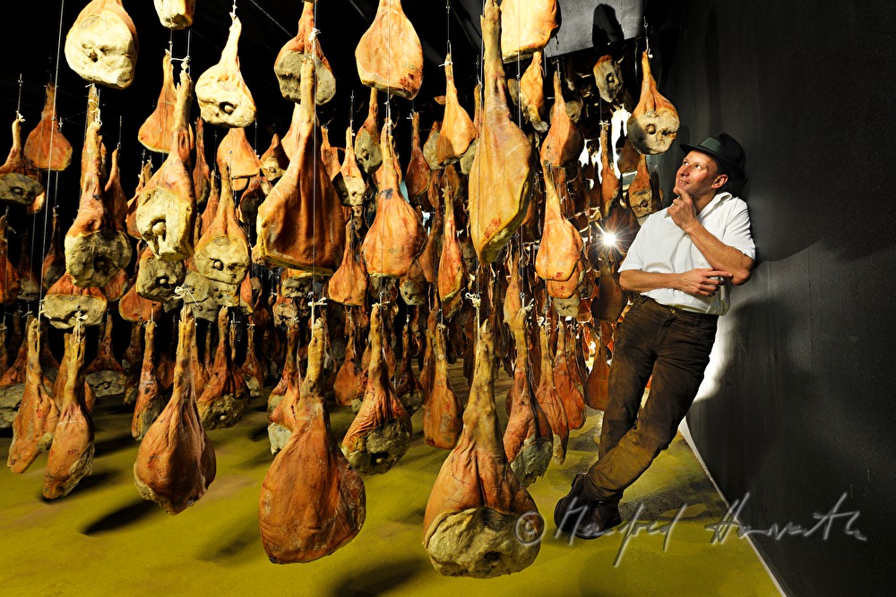 Franz Habel in the ripening room with Vulcano (air dried cured ham)