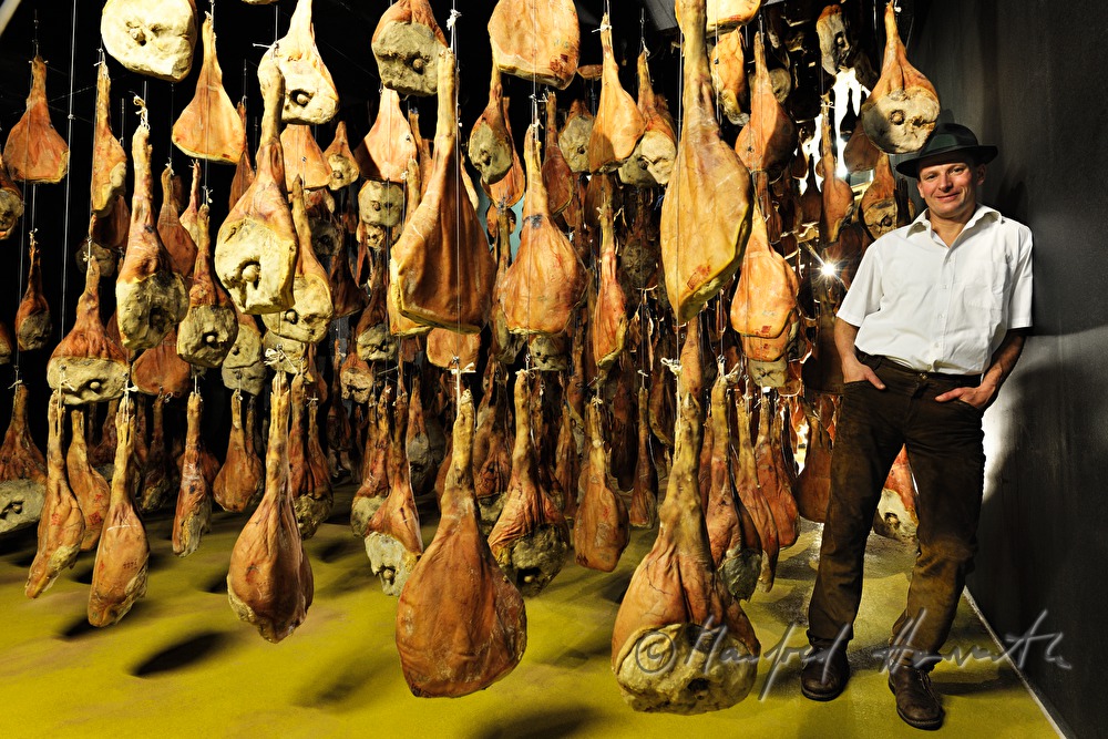 Franz Habel in the ripening room with Vulcano (air dried cured ham)