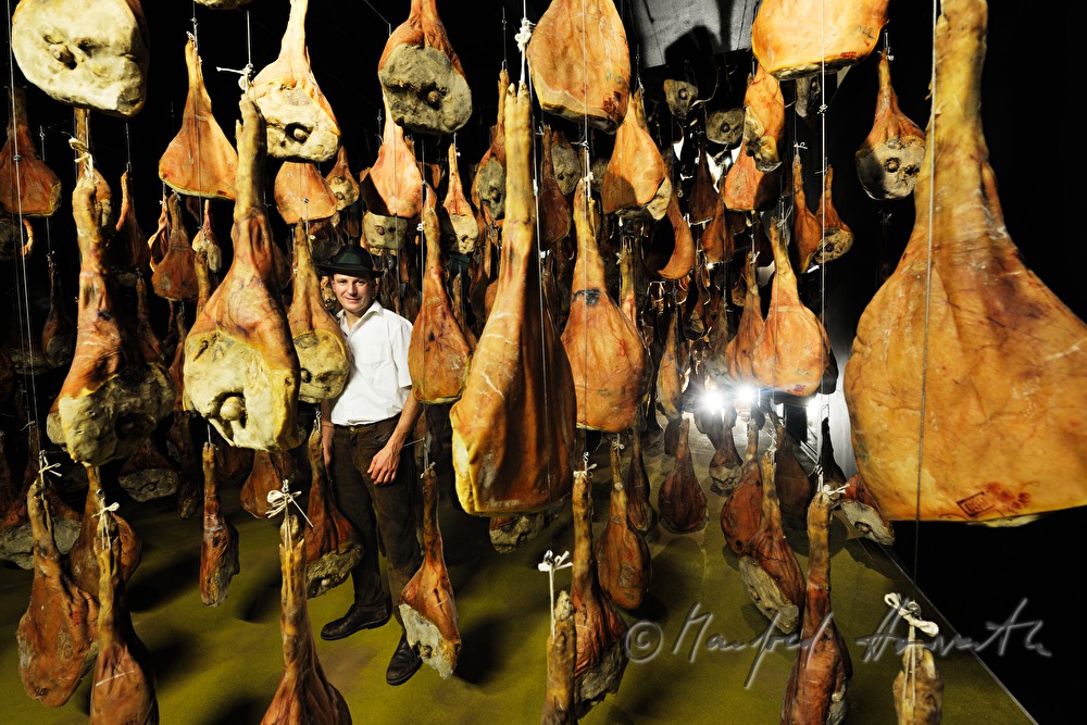 Franz Habel in the ripening room with Vulcano (air dried cured ham)