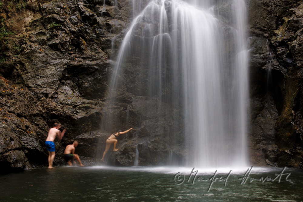 two Costa ricans bathing in the waterfall Montezuma