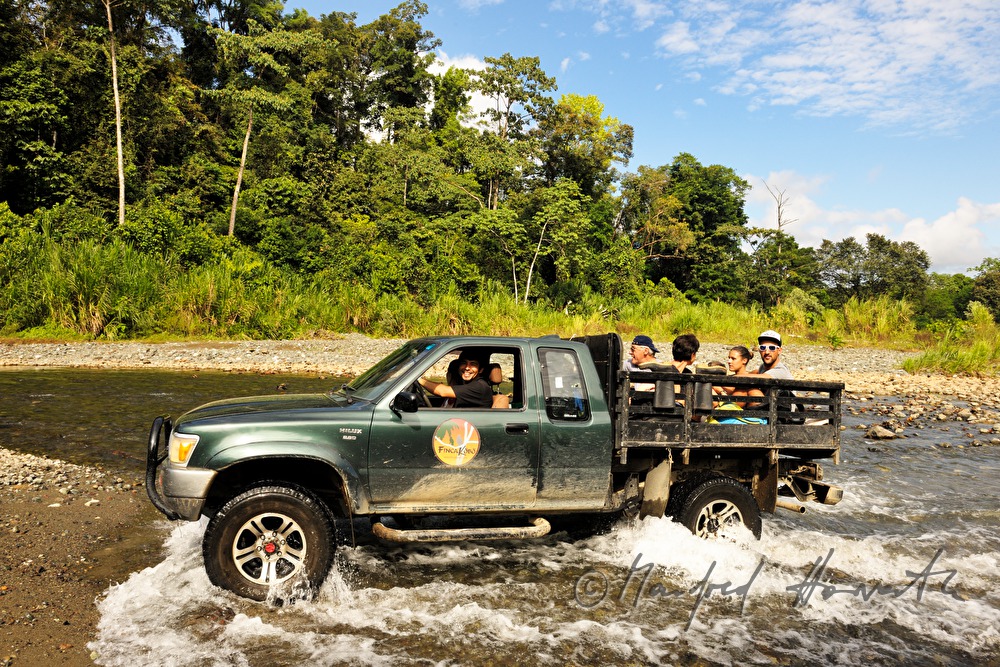 group of tourists passing a river