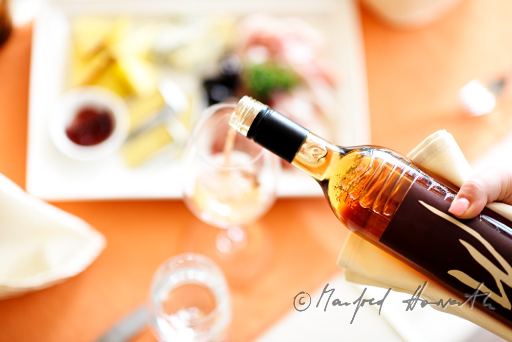 sommelier pours rosé wine
