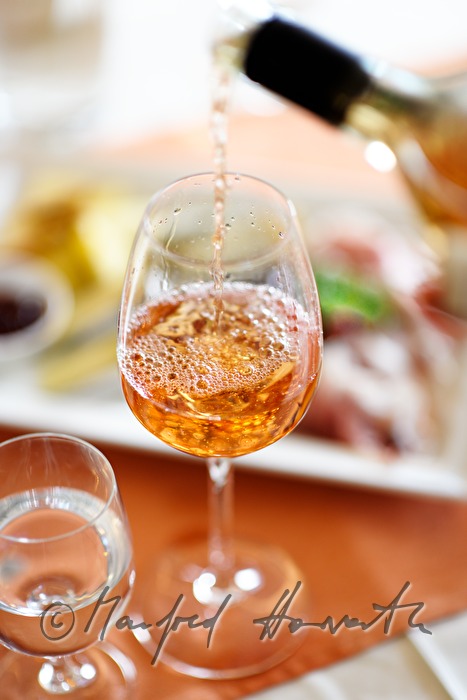 sommelier pours rosé wine