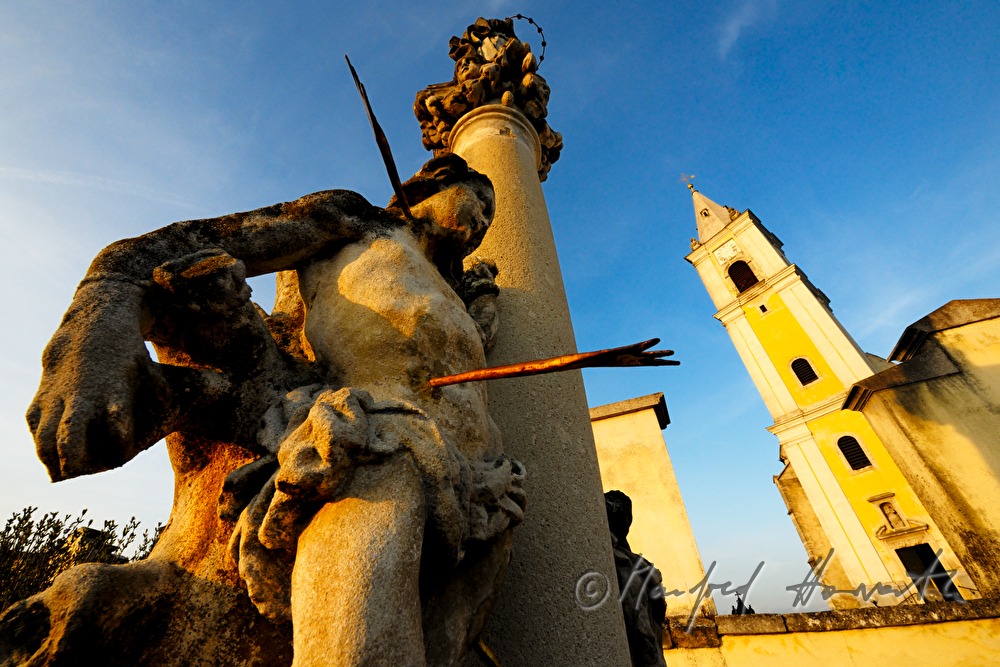 figure of Saint Sebastian and the church