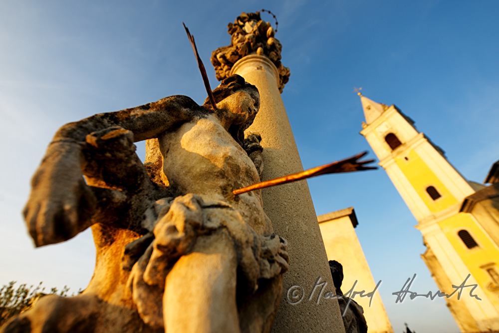 figure of Saint Sebastian and the church