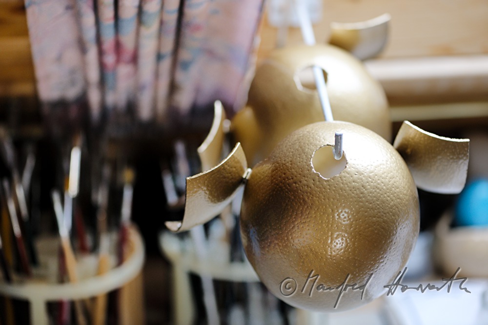 ostrich eggs painted in gold in the workshop