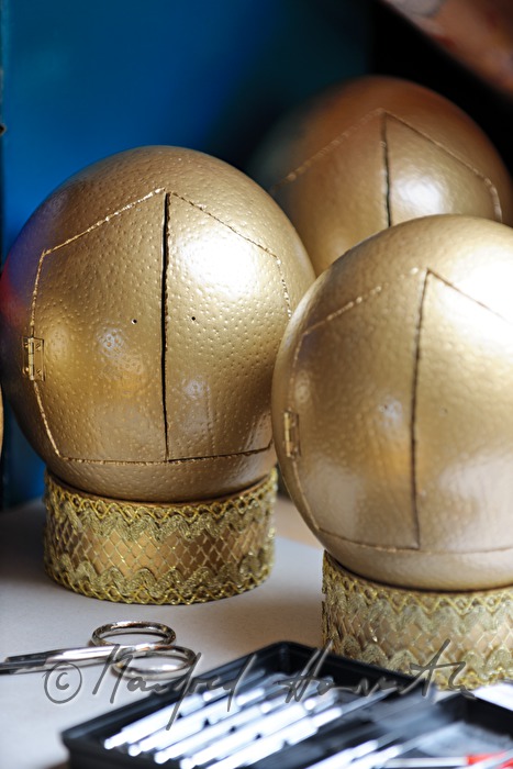 ostrich eggs painted in gold in the workshop