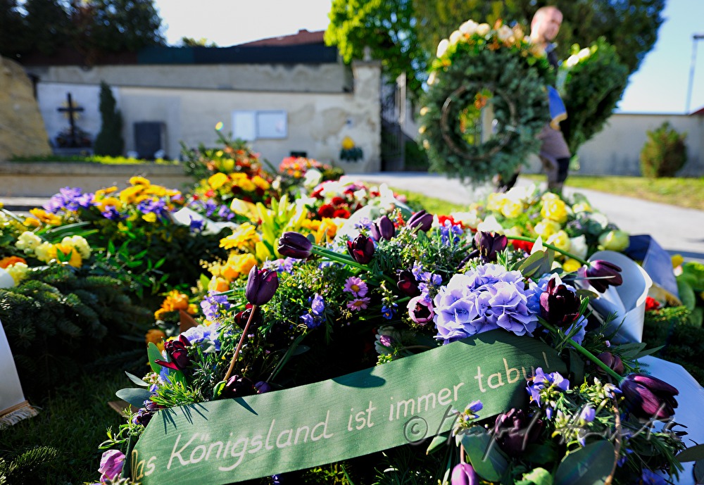 fresh grave with garlands and flowers