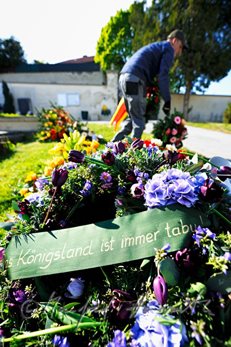 fresh grave with garlands and flowers