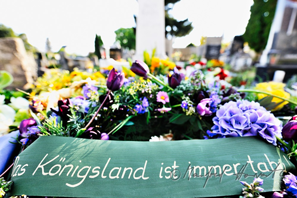 fresh grave with garlands and flowers