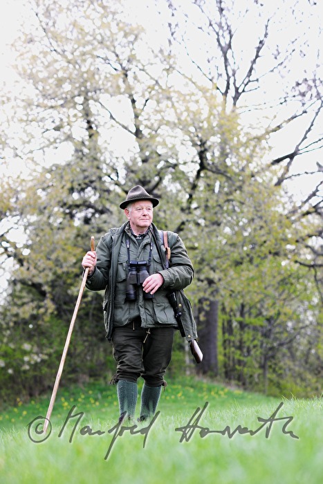 gamekeeper in the morning walking to the deer stand
