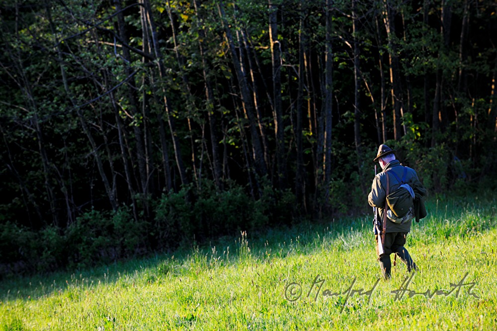 gamekeeper in the morning walking to the deer stand