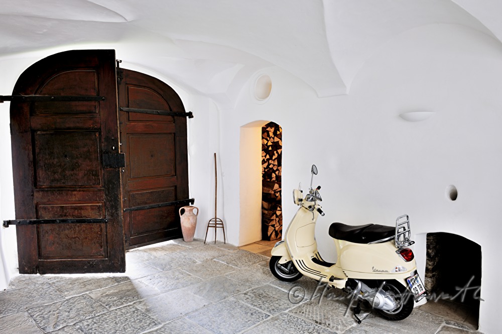 doorway with motor  scooter and wood store