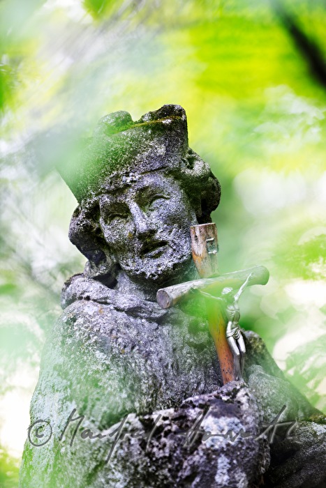 stone sculpture of Saint Nepumuk in the garden