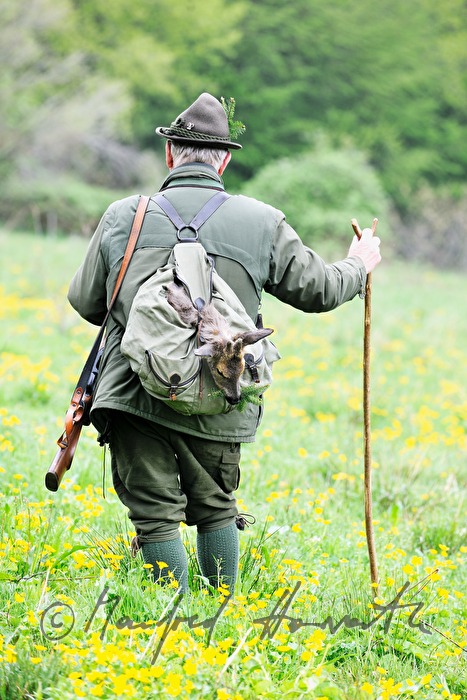 gamekeeper with newly hunted deer in the knapsack