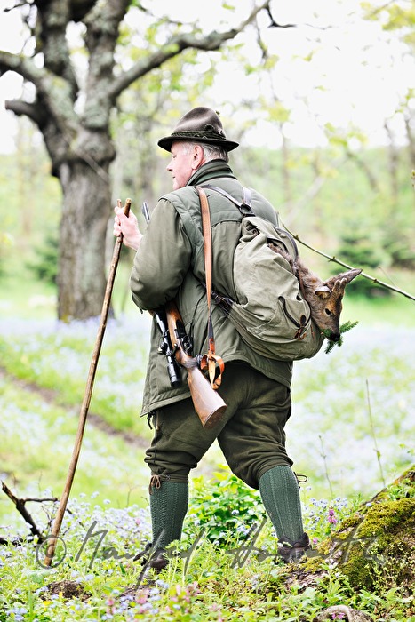 gamekeeper with newly hunted deer in the knapsack