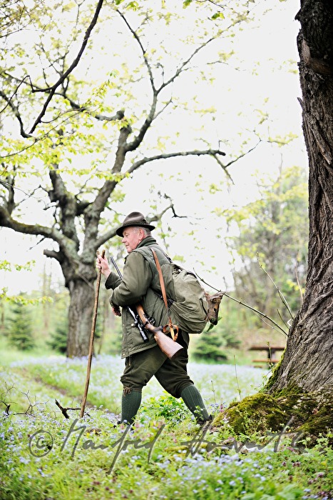 gamekeeper with newly hunted deer in the knapsack