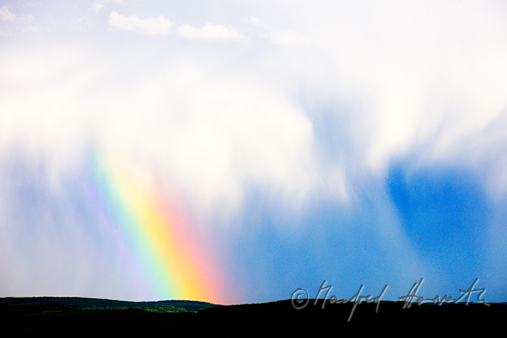 thunderclouds and rainbow