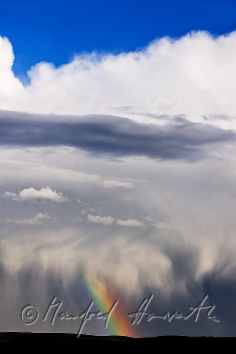 thunderclouds and rainbow