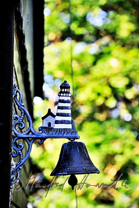 ship bell near the entrance of the fishing hut