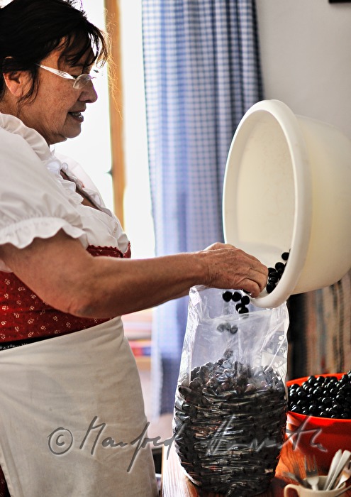 dairymaid with cherries in the kitchen