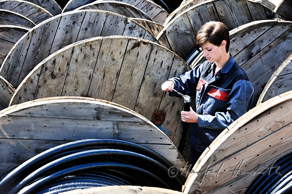 woman electrician and cable extension reels