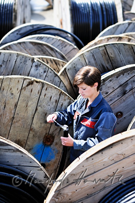 woman electrician and cable extension reels