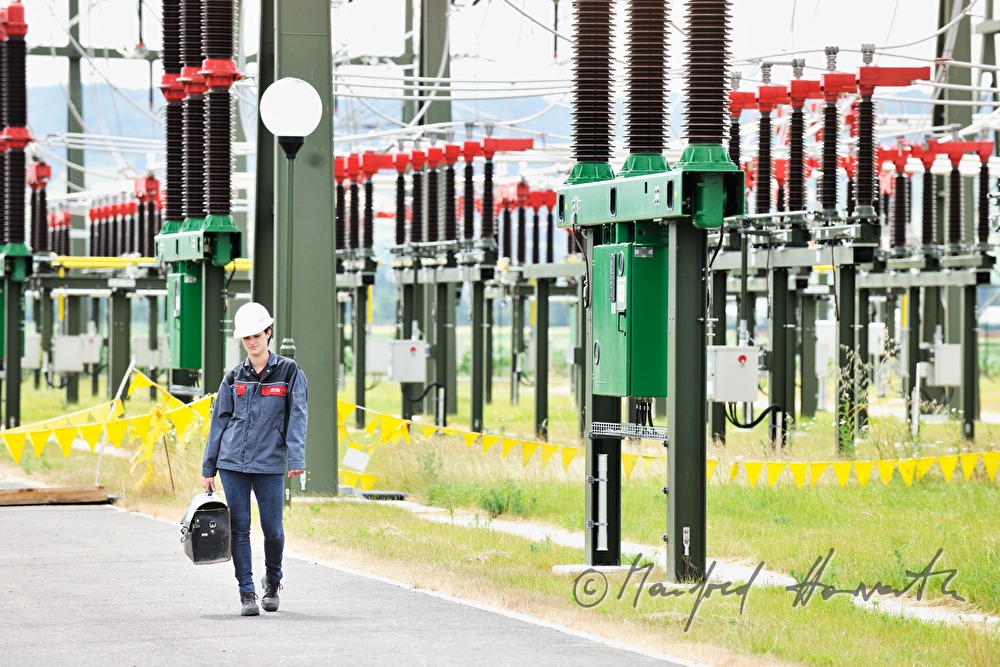 woman electrician with tool box at work